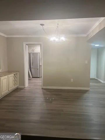 a view of a room with wooden floor and a window