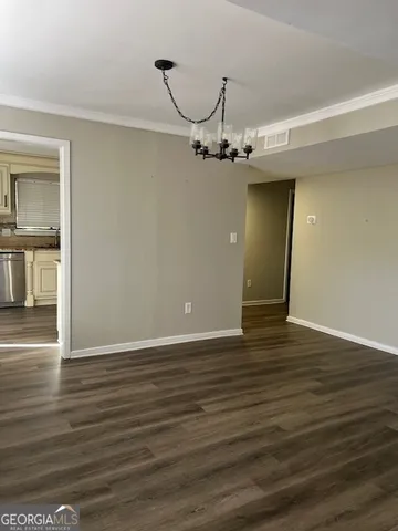 a view of a room with wooden floor and windows