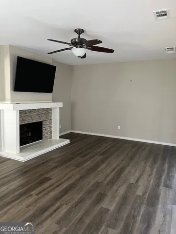 a view of a livingroom with an empty space and a fireplace