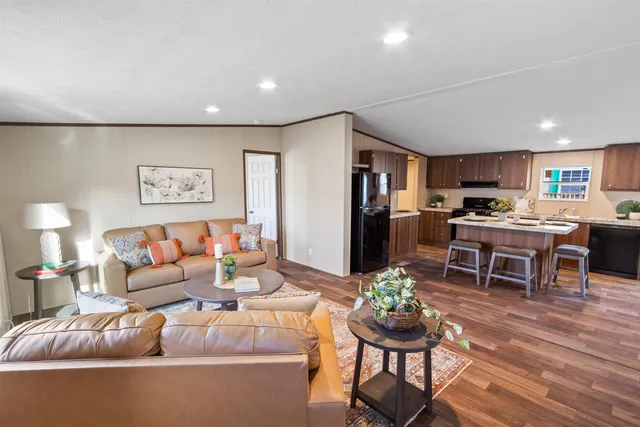a living room with furniture and kitchen view