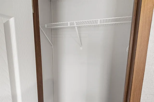 a view of a room with a wooden door