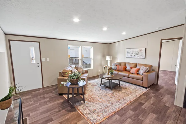 a living room with furniture and flowers