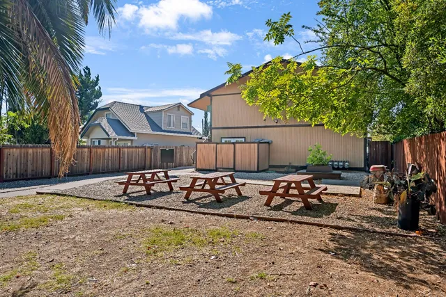 a view of a house with backyard and sitting area