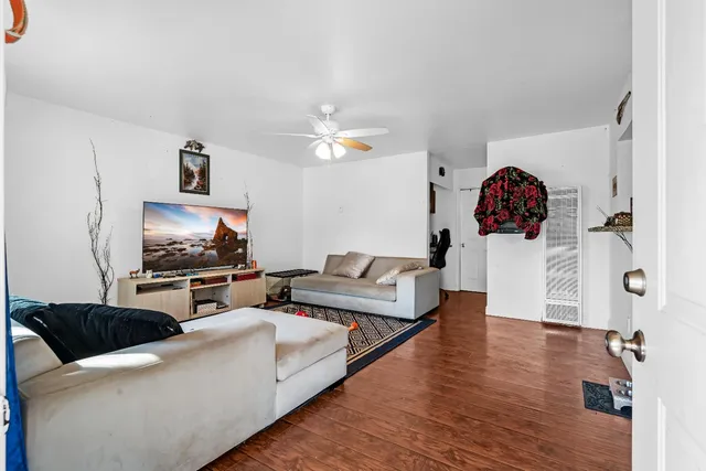 an aerial view of a house with outdoor space and trees all around