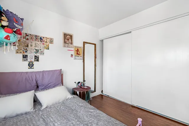 an empty room with wooden floor and white walls