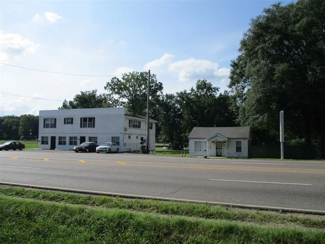 a house view with a sitting space and garden