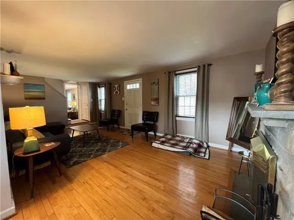 a living room with furniture a window and a flat screen tv