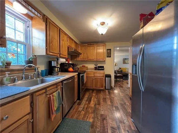 a kitchen with counter top space a sink appliances and cabinets