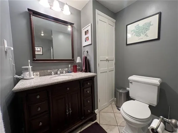 a bathroom with a toilet a sink and mirror