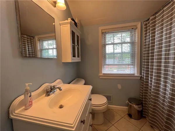 a bathroom with a sink toilet and window