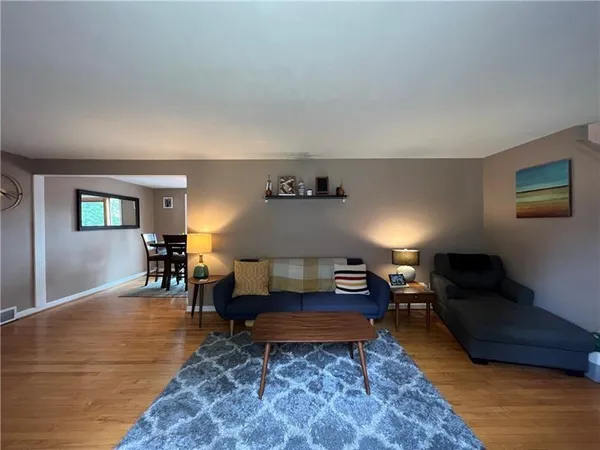 a living room with furniture and a rug
