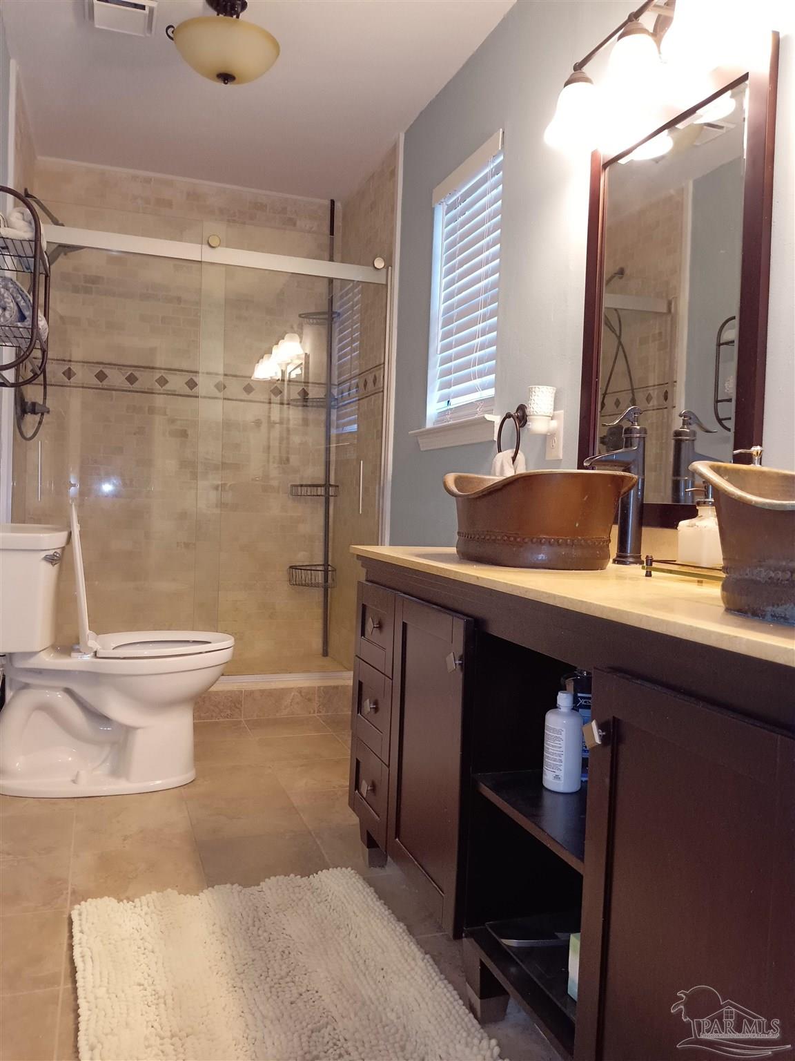 5837 Hermitage Circle Milton, FL 32570 - Photo 21 of 31 a bathroom with a sink a toilet and a mirror