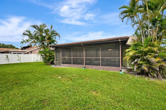 a view of house with yard and entertaining space