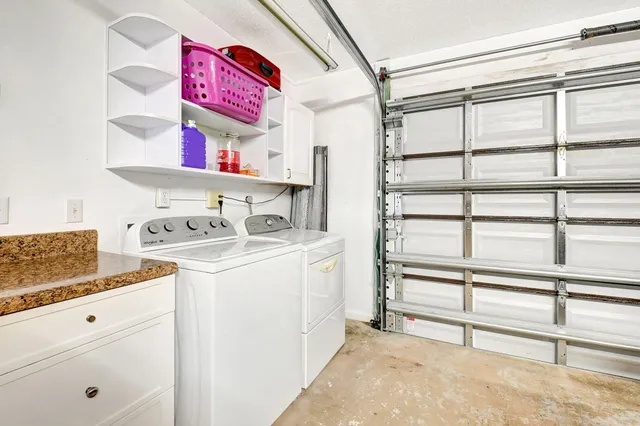 an aerial view of a house with a yard and a garage