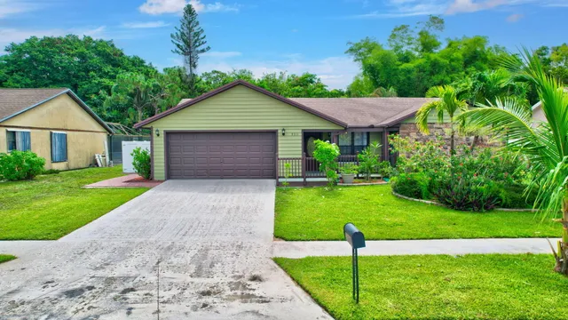 a aerial view of a house in front of a house with a yard