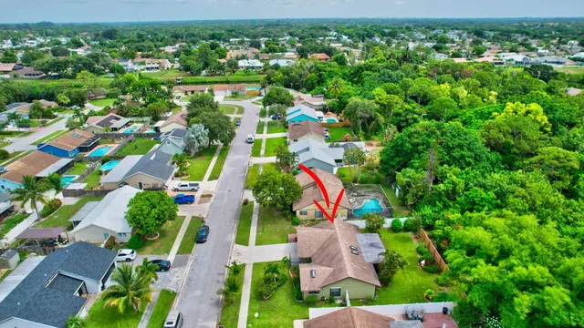 an aerial view of residential houses with outdoor space and street view
