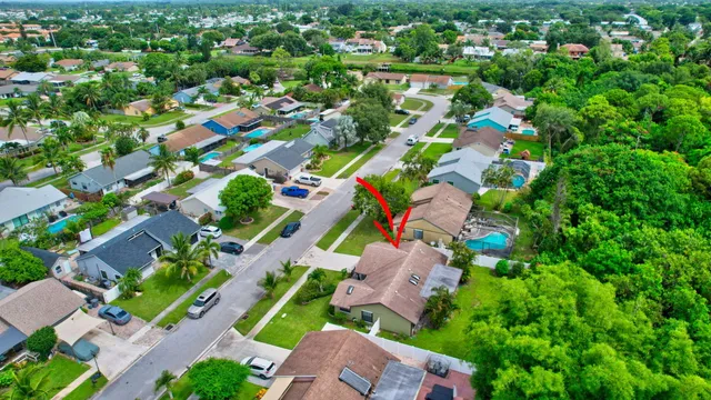 an aerial view of residential houses with outdoor space and street view