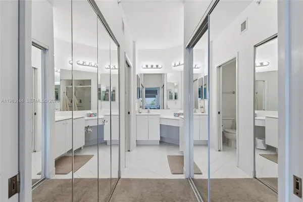 a bathroom with a glass shower door and a mirror