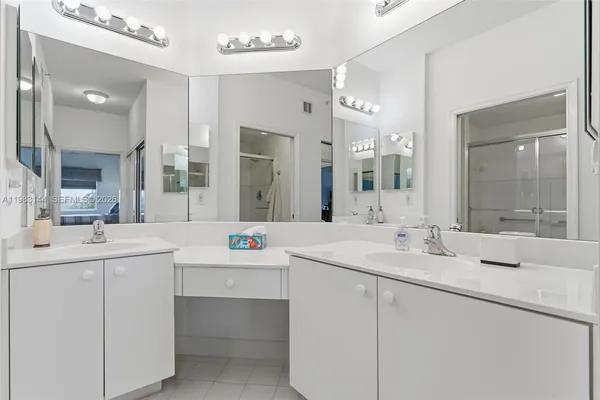 a bathroom with a sink vanity and mirror