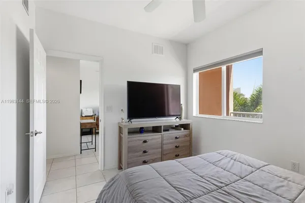 a bedroom with a bed and a flat screen tv