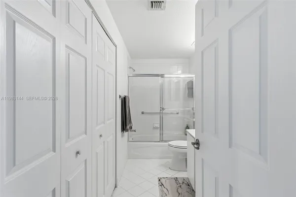 a bathroom with a glass shower door