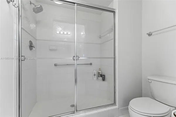 a bathroom with a shower and toilet