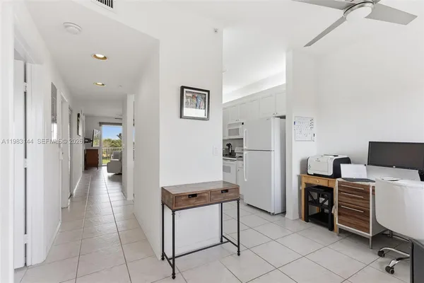 a view of a workspace with furniture and a view of kitchen