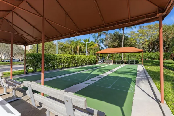 a view of yard with a table and chair under an umbrella