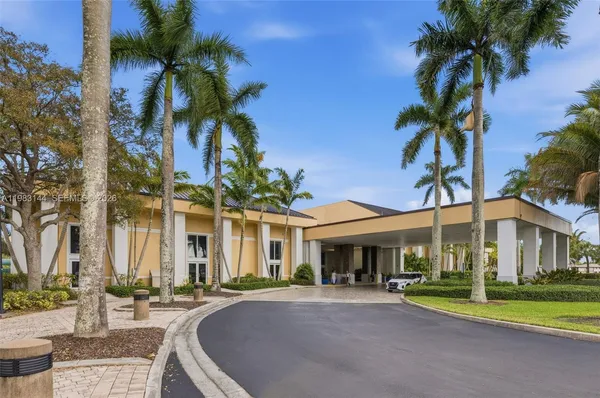 a front view of a house with a garden and patio