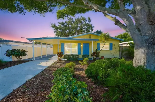 a front view of a house with a yard and outdoor seating