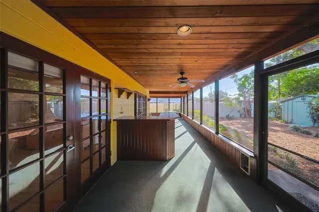 an aerial view of a houses with a swimming pool