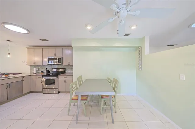 a kitchen with stainless steel appliances granite countertop a sink refrigerator and microwave