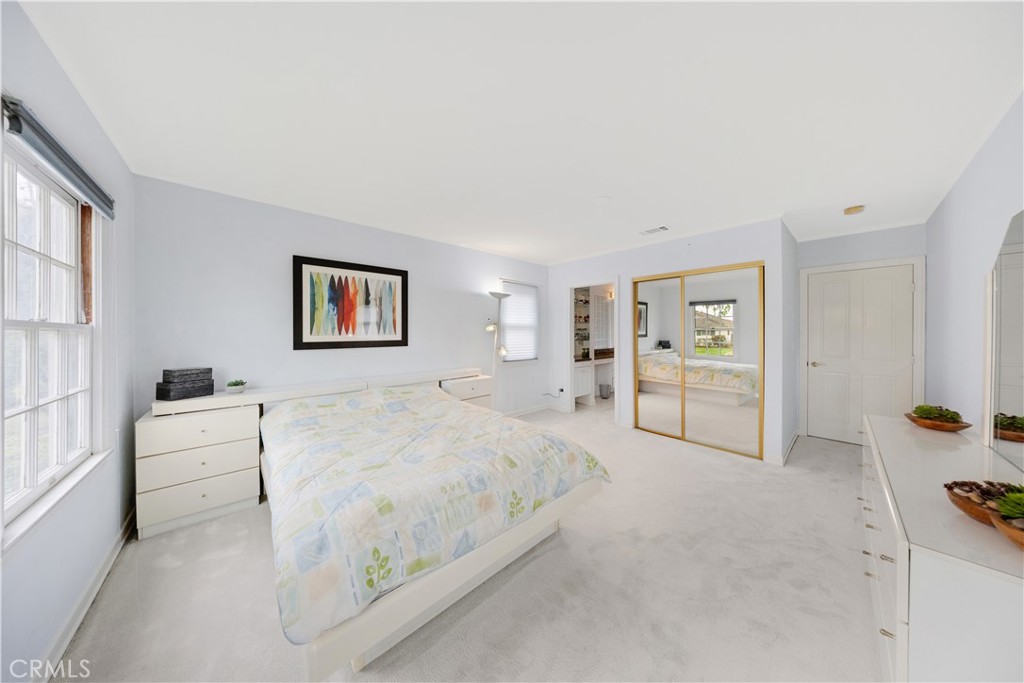 2835 Devonport Road San Marino, CA 91108 - Photo 31 of 54 a spacious bedroom with a bed a table and painting on the wall