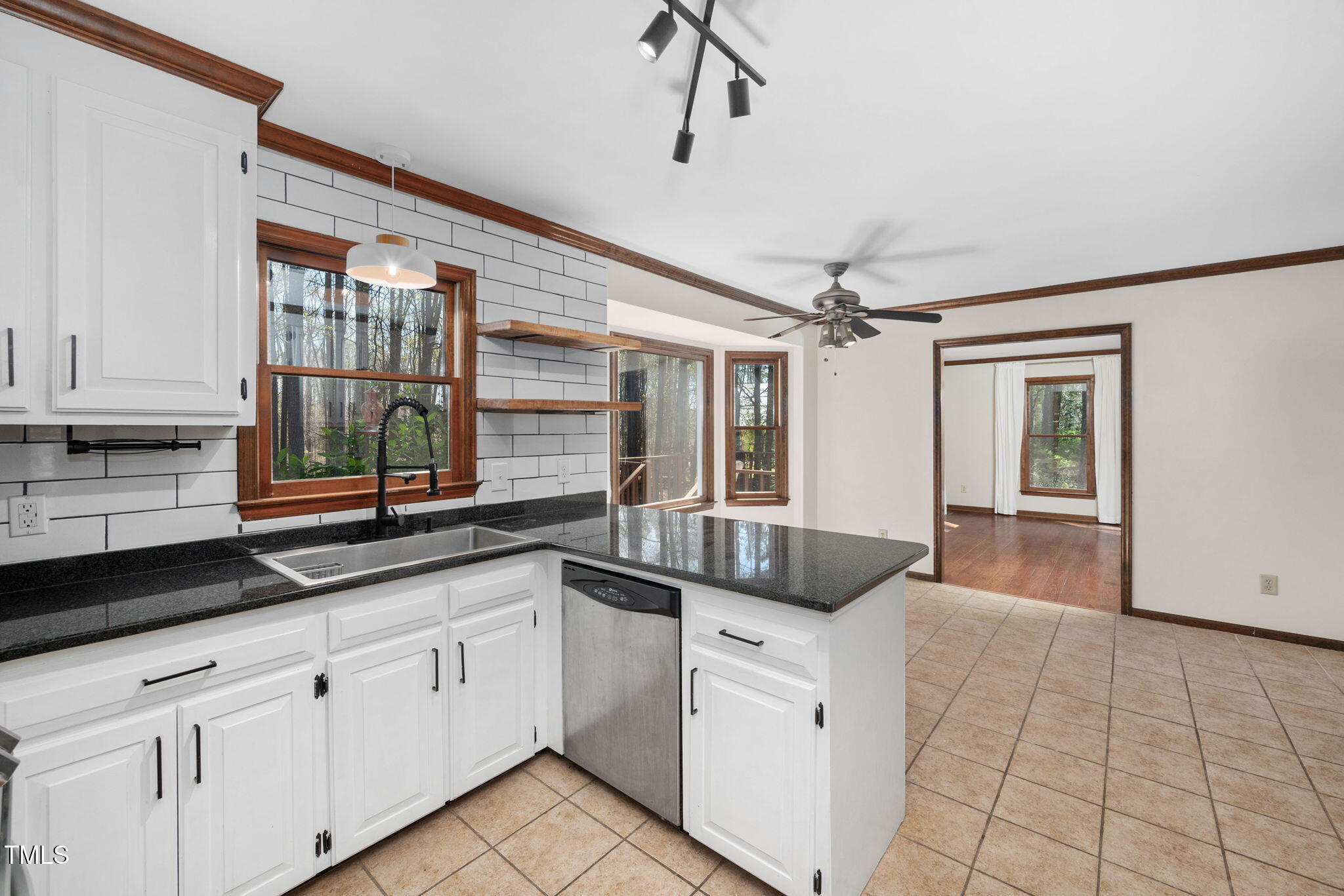 7917 Blaney Franks Road Apex, NC 27539 - Photo 9 of 50 a open kitchen with granite countertop a sink and white cabinets