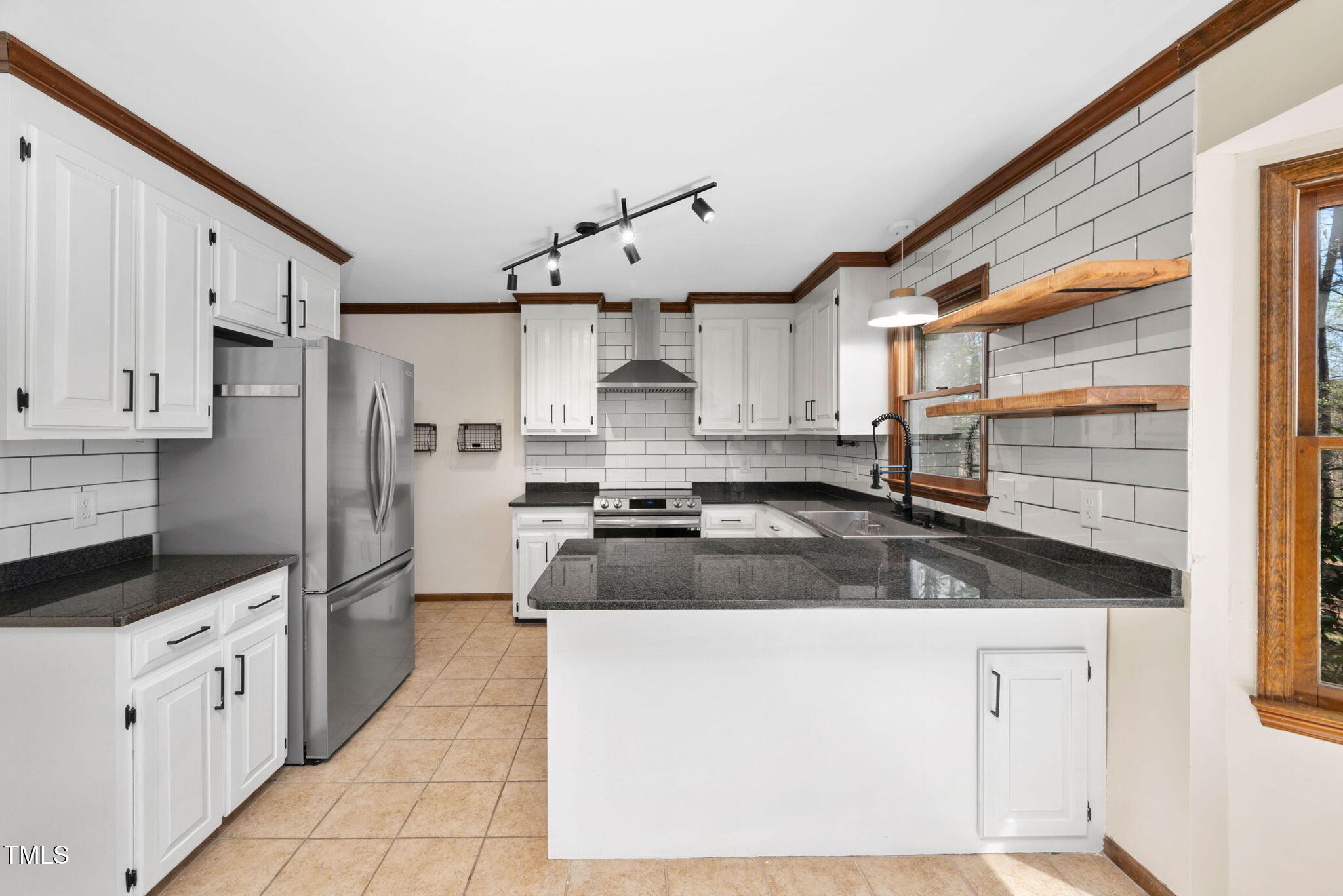 7917 Blaney Franks Road Apex, NC 27539 - Photo 11 of 50 a kitchen with granite countertop a sink stainless steel appliances and cabinets