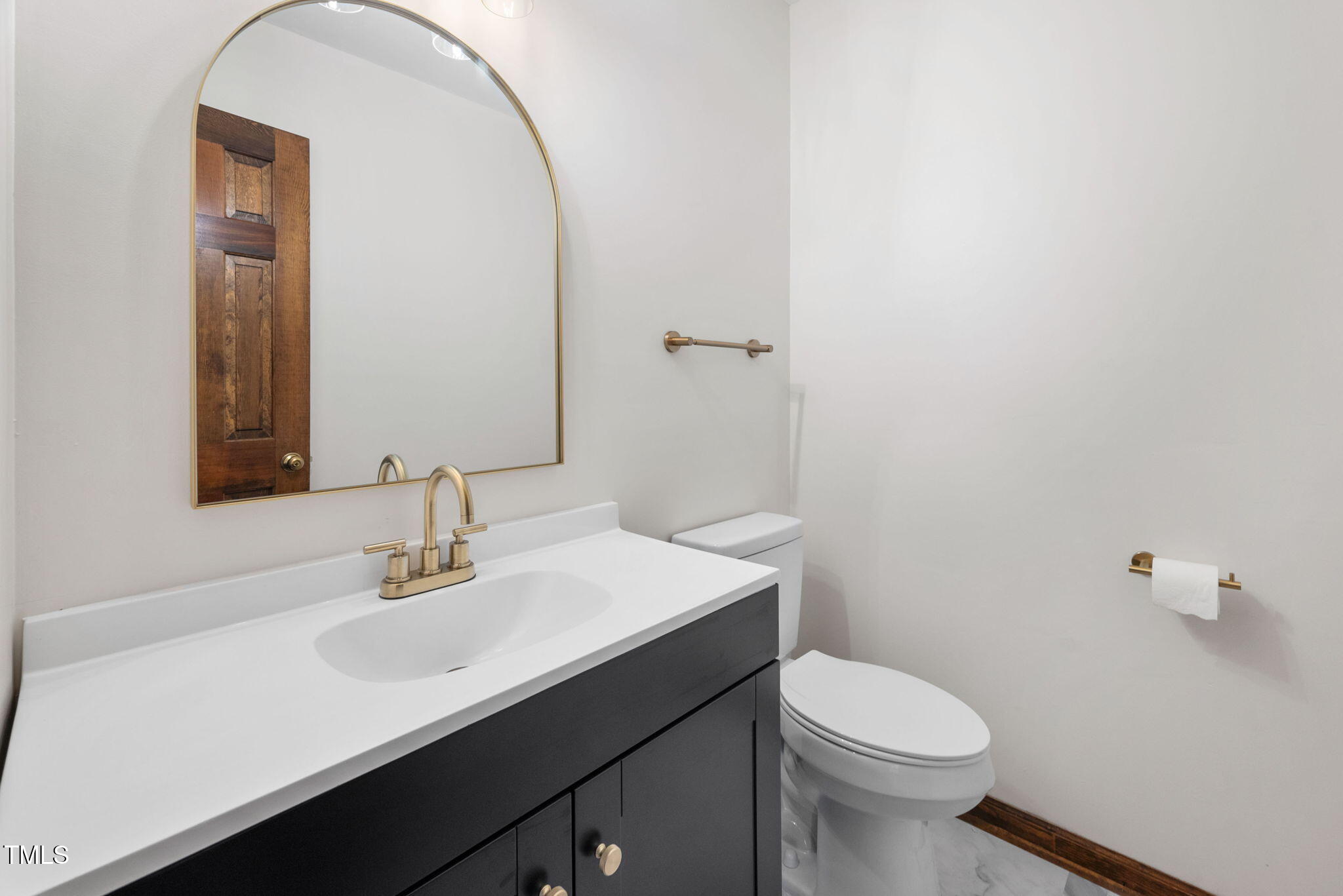 7917 Blaney Franks Road Apex, NC 27539 - Photo 15 of 50 a bathroom with a sink a toilet and mirror