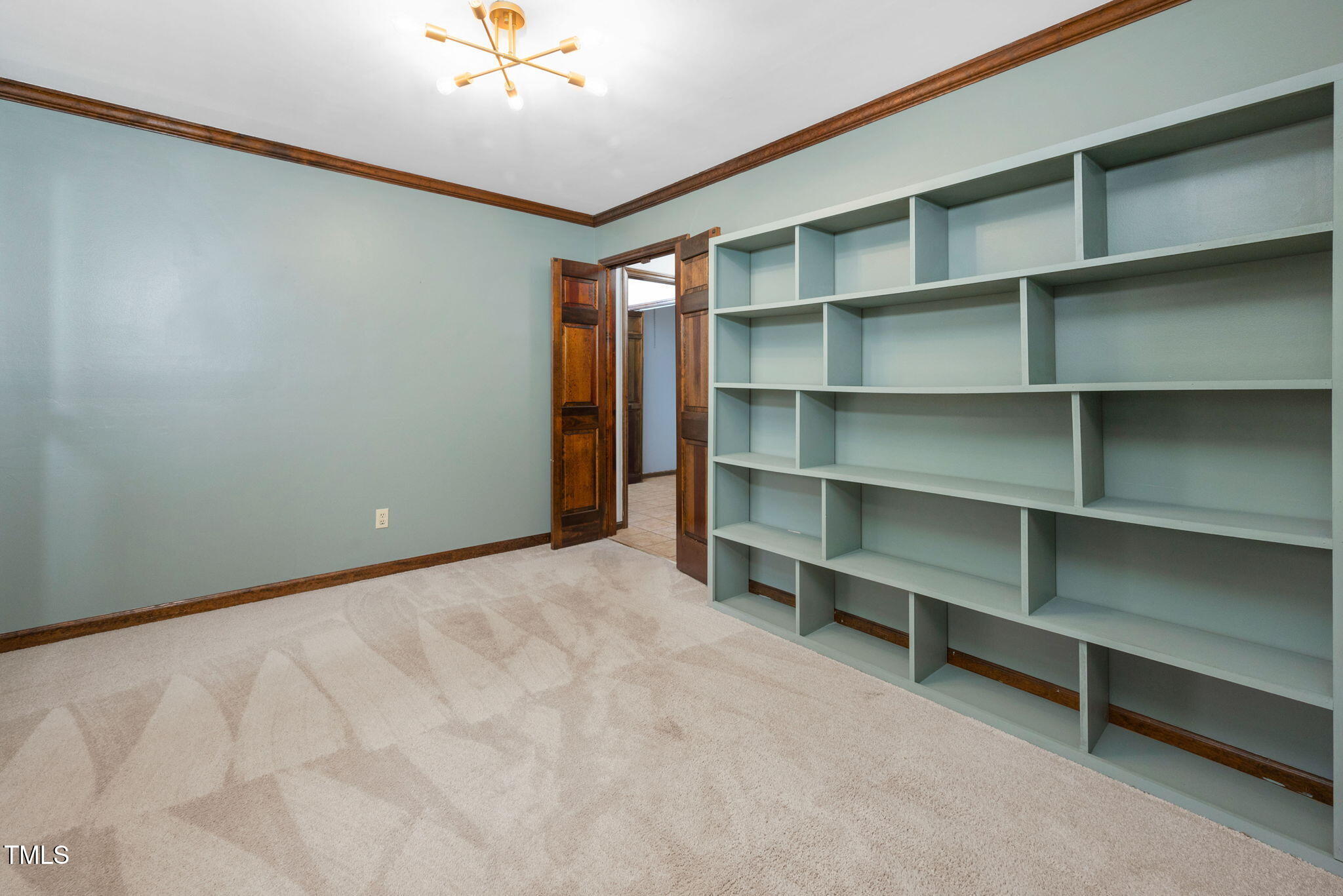 7917 Blaney Franks Road Apex, NC 27539 - Photo 16 of 50 a view of an empty room with a cabinet and a window