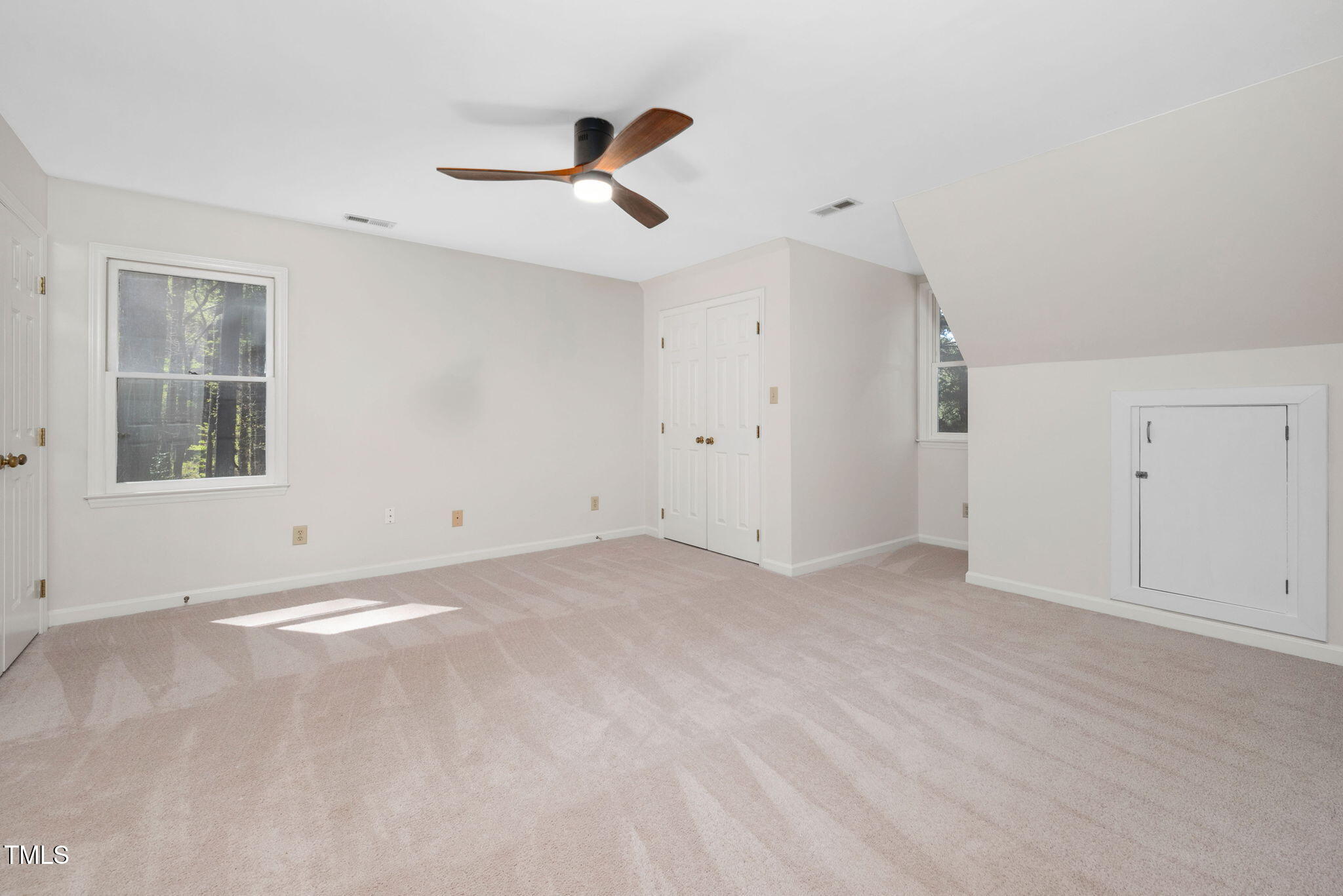 7917 Blaney Franks Road Apex, NC 27539 - Photo 19 of 50 an empty room with windows and fan