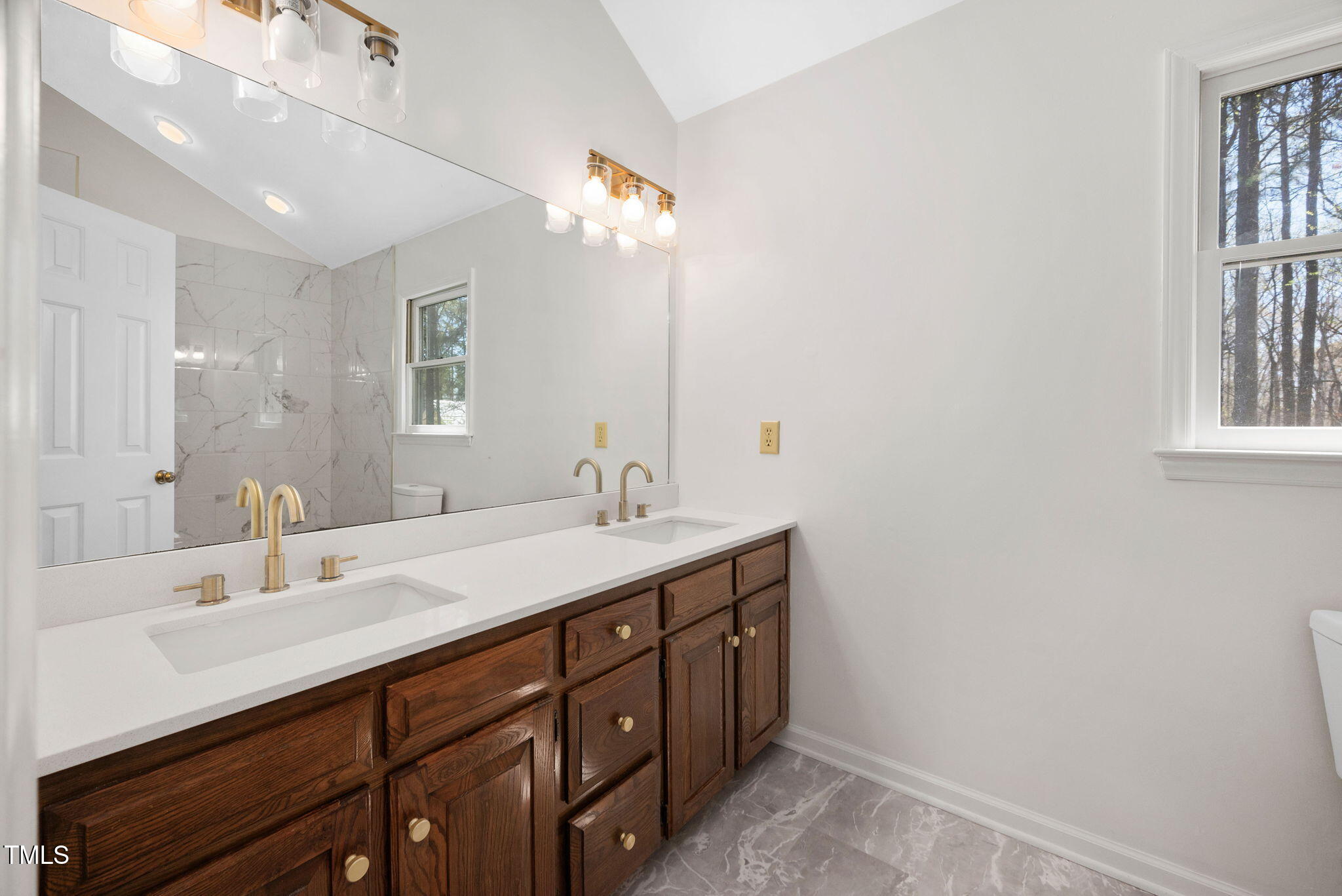 7917 Blaney Franks Road Apex, NC 27539 - Photo 20 of 50 a bathroom with a sink double vanity and a mirror
