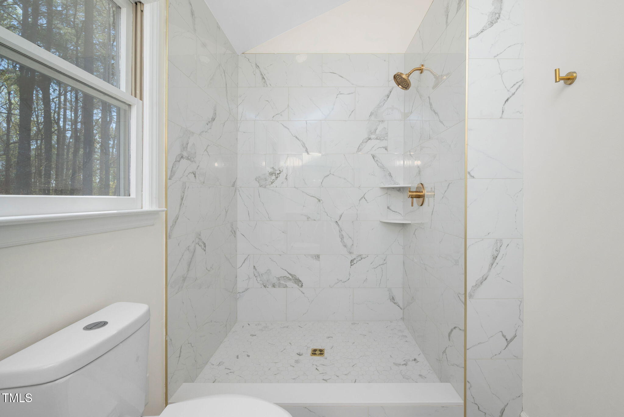 7917 Blaney Franks Road Apex, NC 27539 - Photo 21 of 50 a bathroom with a shower and toilet