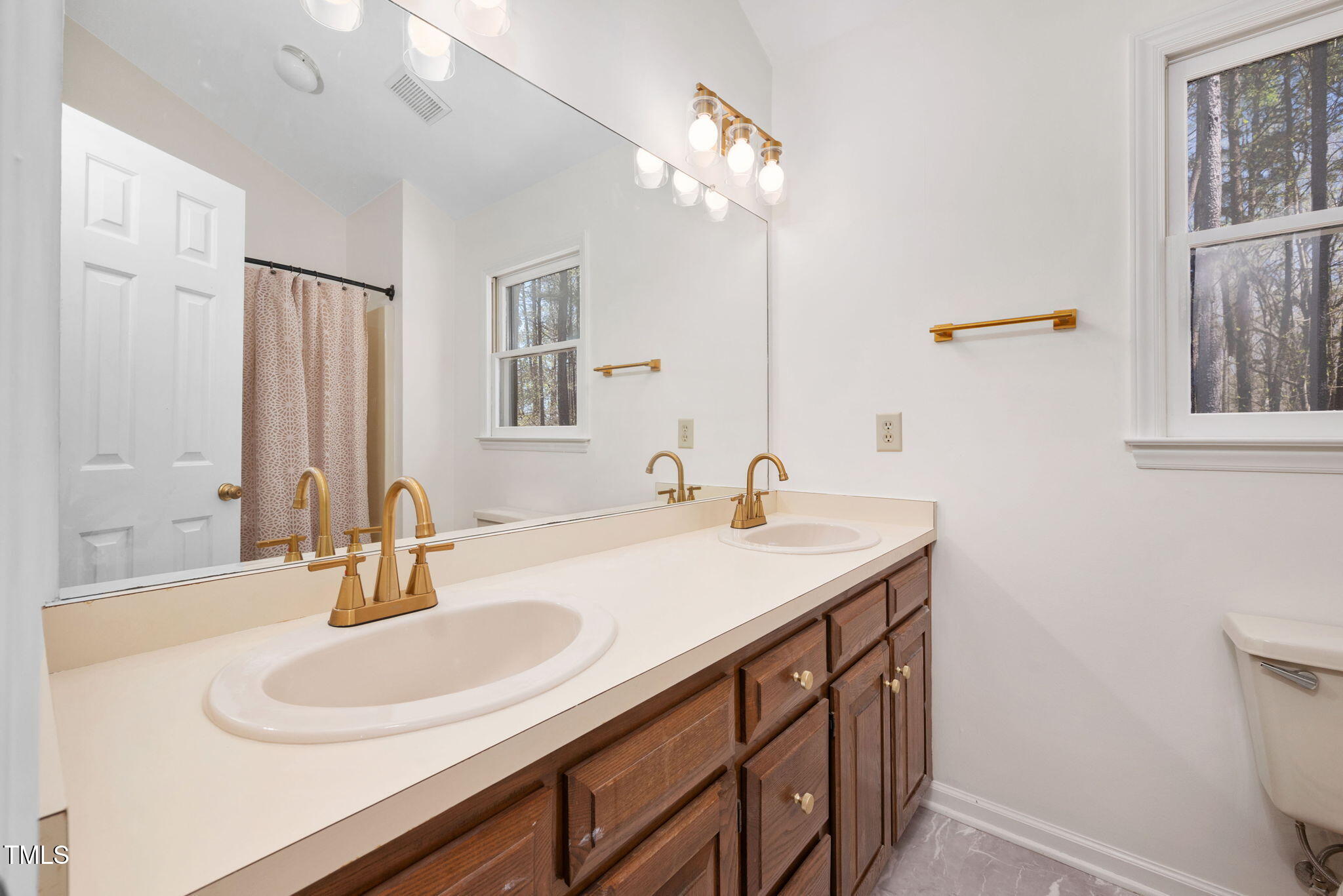 7917 Blaney Franks Road Apex, NC 27539 - Photo 26 of 50 a bathroom with a sink and a mirror