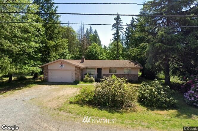 17065 Southeast Wax Road Covington, WA 98042 - Photo 1 of 1 a view of a house with a large tree and a yard