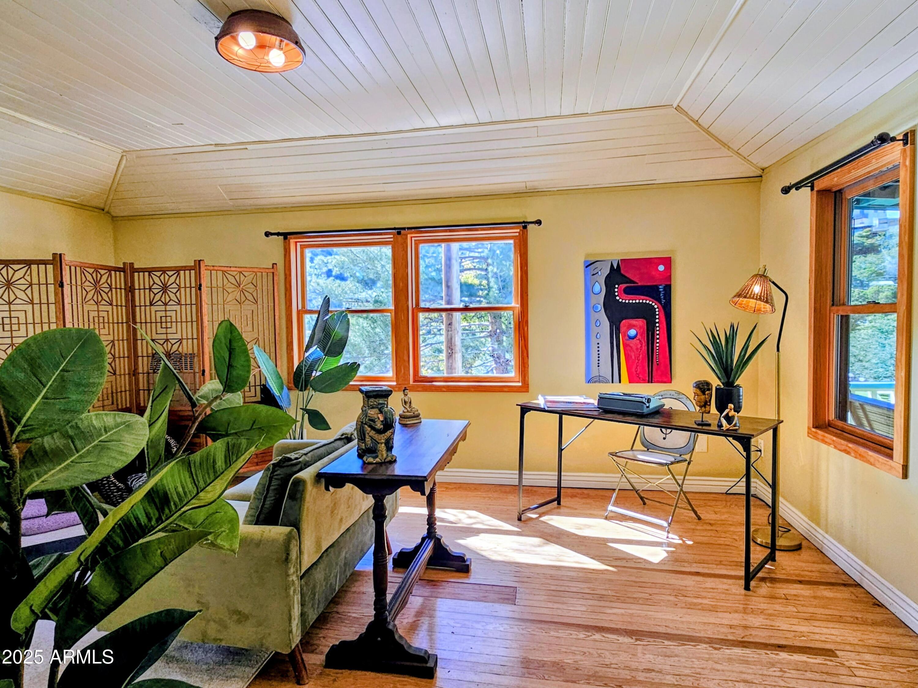 79 Ok Street Bisbee, AZ 85603 - Photo 29 of 33 a view of a livingroom with furniture a floor to ceiling window and potted plants