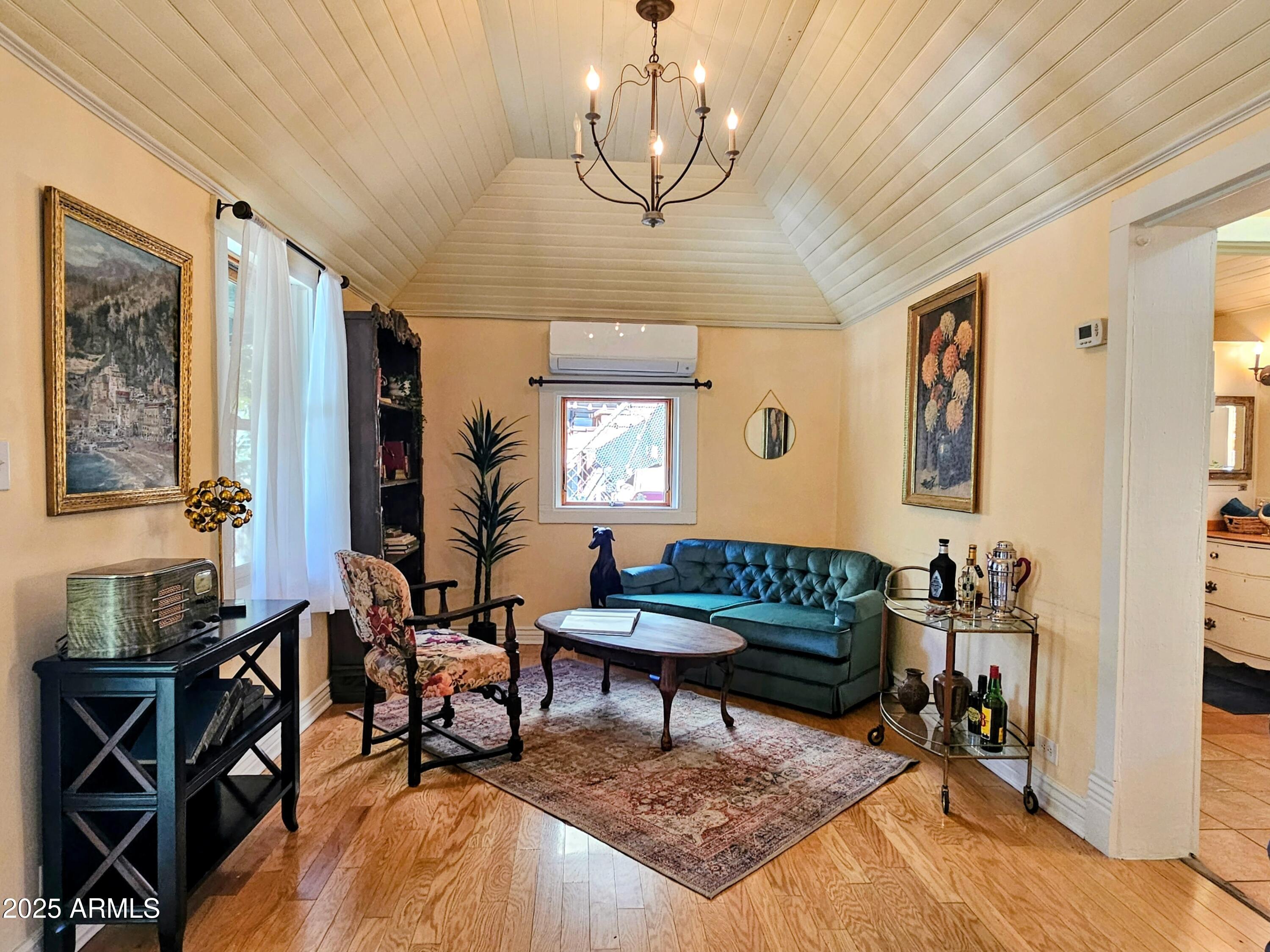 79 Ok Street Bisbee, AZ 85603 - Photo 3 of 33 a living room with furniture and a chandelier