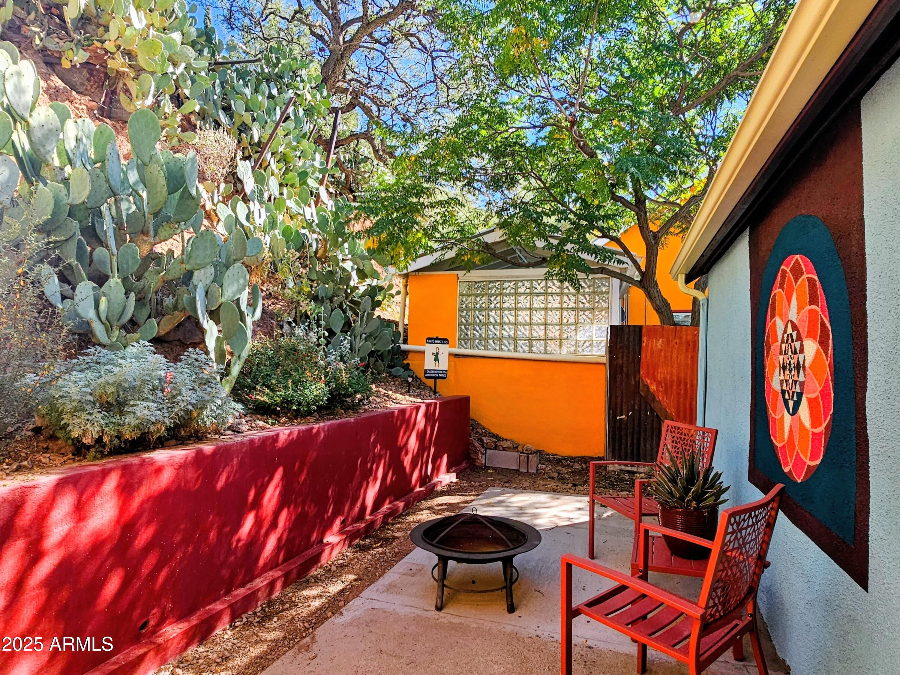 79 Ok Street Bisbee, AZ 85603 - Photo 33 of 33 a view of a chairs and fire pit in the backyard of a house