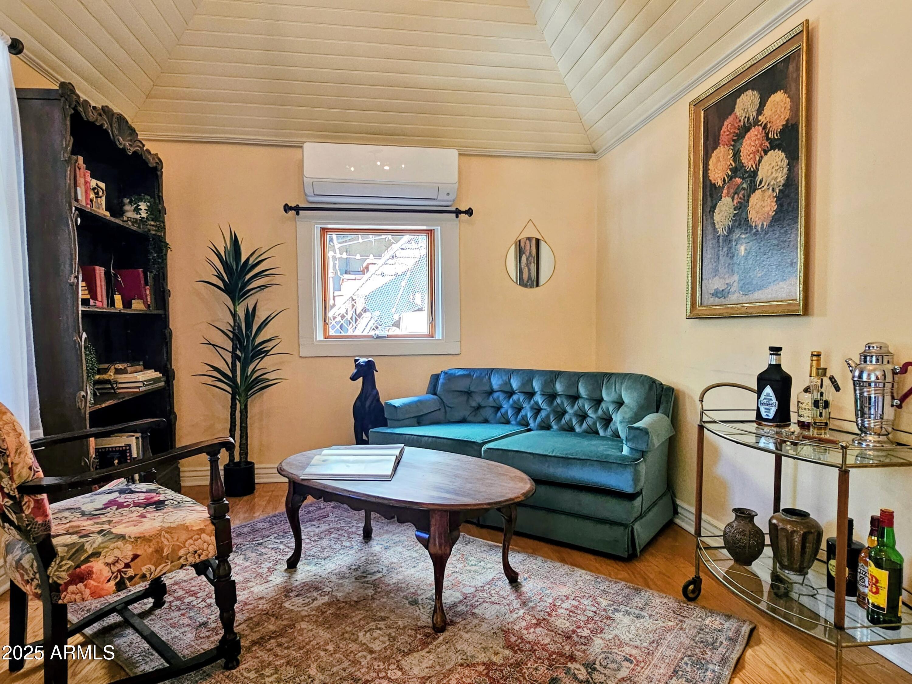 79 Ok Street Bisbee, AZ 85603 - Photo 5 of 33 a living room with furniture a rug and a bookshelf