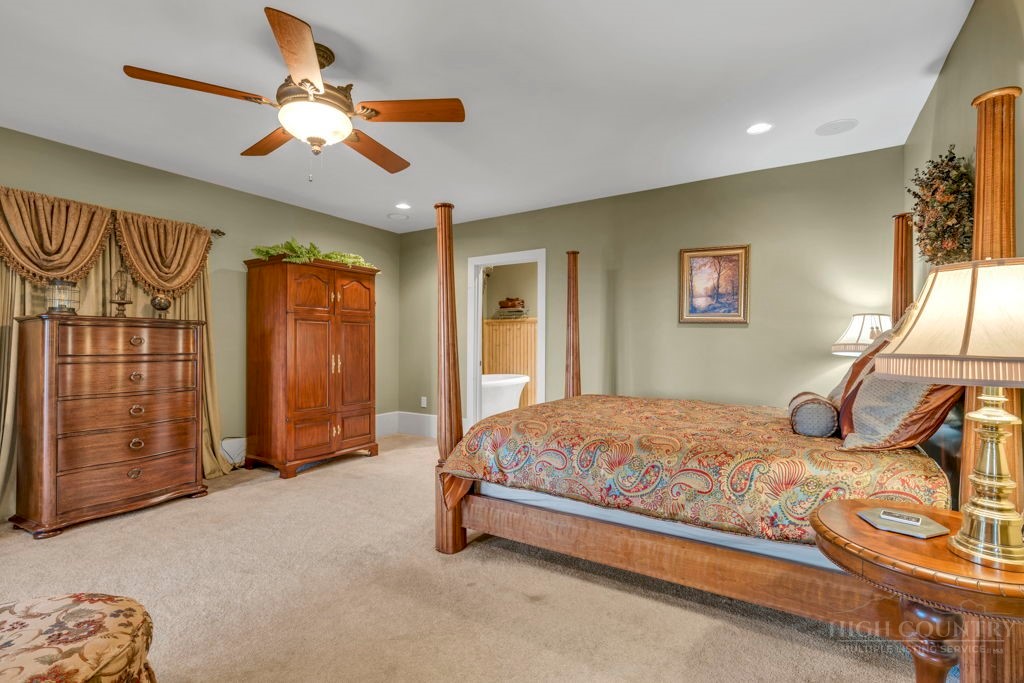 160 Outback Road Ferguson, NC 28624 - Photo 38 of 49 a bedroom with a bed and a chandelier