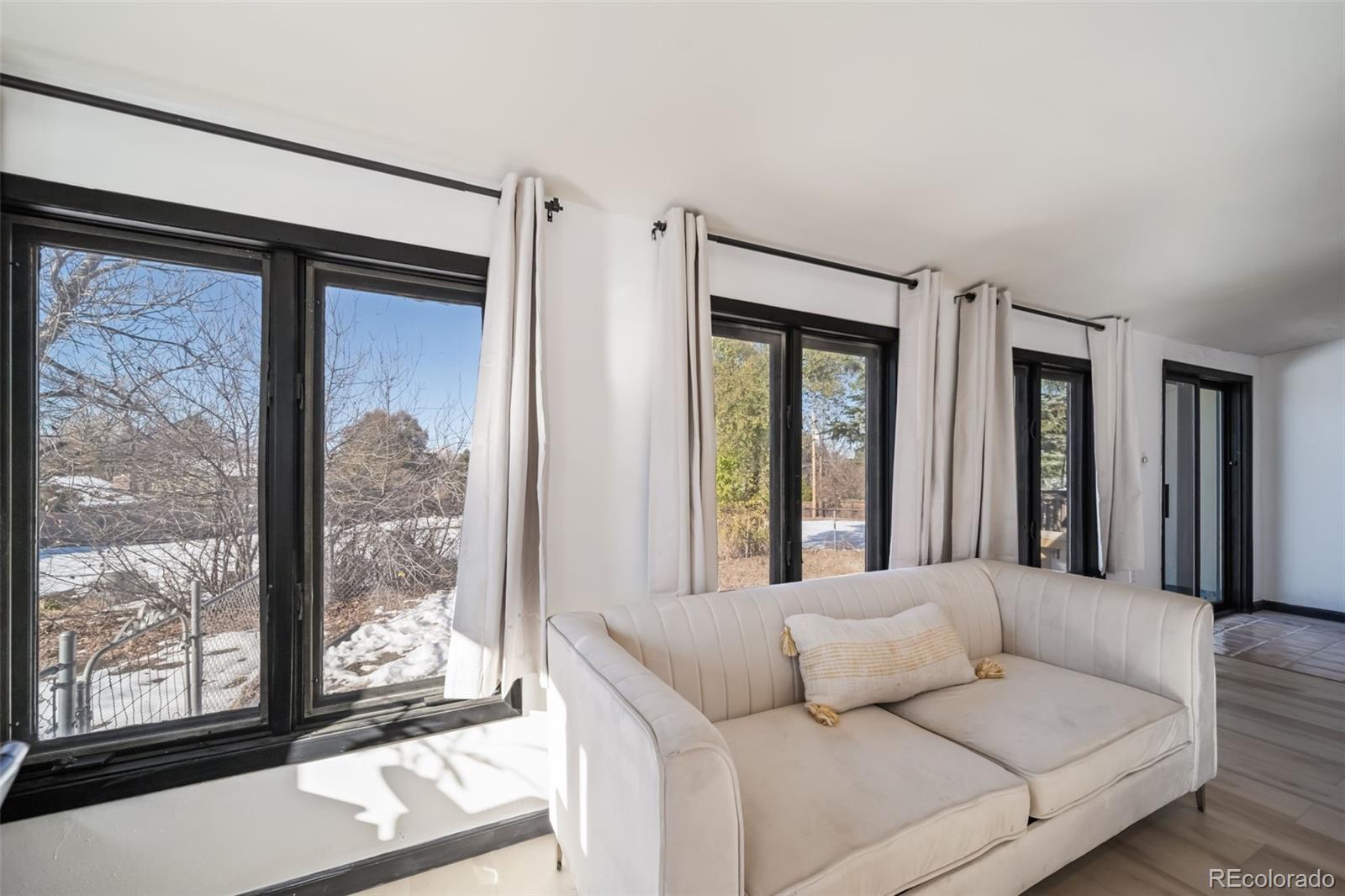 6101 South University Boulevard Centennial, CO 80121 - Photo 15 of 50 a living room with furniture and a window