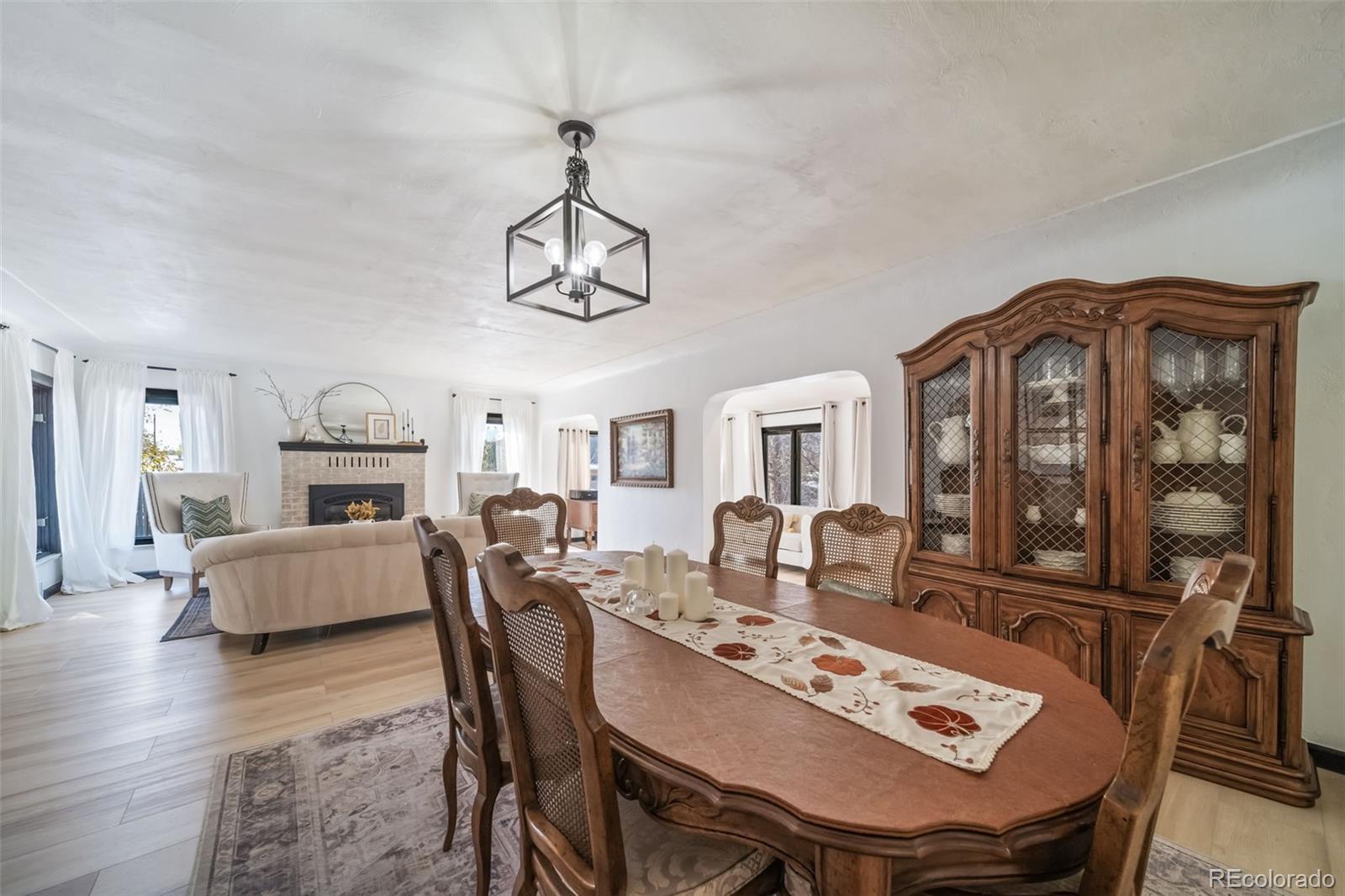 6101 South University Boulevard Centennial, CO 80121 - Photo 17 of 50 a view of a dining room with furniture a chandelier and wooden floor