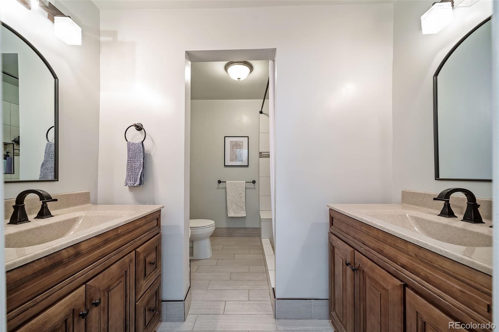 6101 South University Boulevard Centennial, CO 80121 - Photo 28 of 50 a bathroom with a sink and a mirror